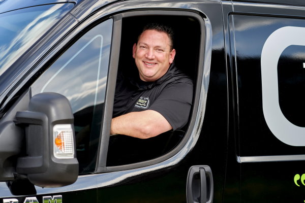 Master Plumber Bill Fry The Plumbing Guy in drivers seat of company van